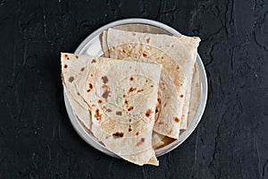 Indian flat bread Chapati, roti made of whole wheat flour and baked black background