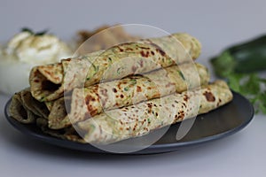 Indian flat bread made of whole wheat flour, grated zucchini and coriander leaves. Served with spiced yogurt