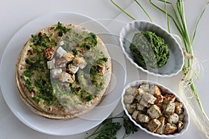 Indian flat bread smeared with green garlic condiment and served with sauteed cottage cheese