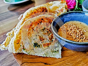 Indian flatbread garlic roti naan with Satay peanut dipping curry sauce