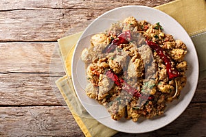 Indian food: Chettinad chicken curry with chili pepper closeup.