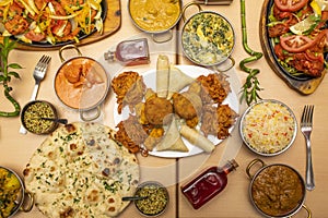 Indian food dishes, with fried chicken tikka masala, garlic naan, yogurt