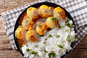 Indian food: Dum aloo potatoes in a sauce with rice close-up. ho