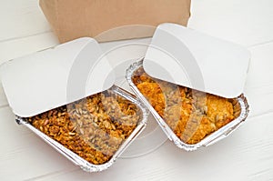 Indian food, fruit pies, subhadra and mithai, foil plates on white background, with seeds, near paper bag, mockup