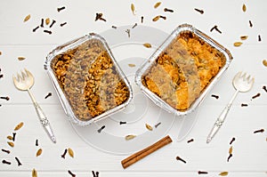 Indian food, fruit pies, subhadra and mithai, foil plates on white background, seeds, spices, cinnamon, with two forks