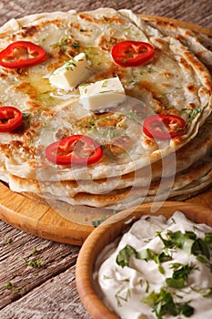 Indian food: hot paratha with butter close-up. vertical