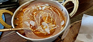 Indian food including curries, spice sauce and naan bread.