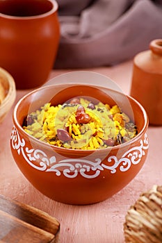 Indian Food Maharashtra Poha with Peanuts in a Pottery Bowl