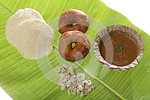 Indian fried snack medu vada & idli with coconut chutney and sambhar. photo