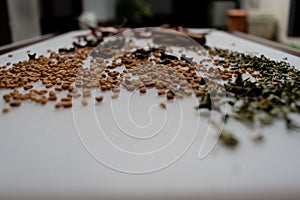 Indian Garam masala powder in bowl and it`s ingredients colourful spices. Served over moody background. selective focus