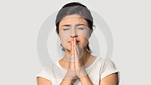 Indian girl believer with prayer hands make wish