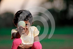 Indian girl child playing with ball