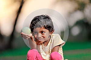 Indian girl child playing with ball