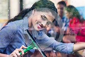 Indian girl cleaning windows