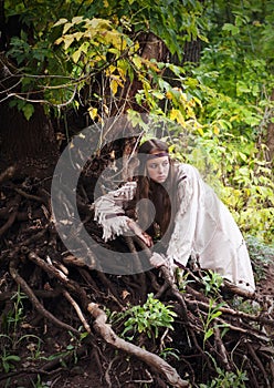 Indian girl in the forest standing near tree