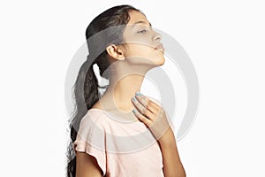indian girl having soreness in the neck due to thyroid