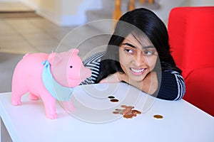 Indian girl looking to her Piggybank
