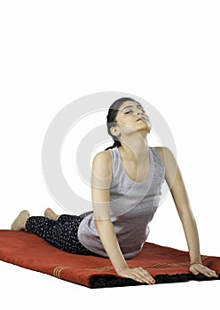 Indian girl performing surya namaskar yoga
