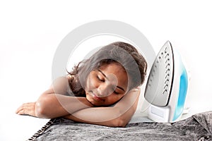 Indian girl sleeping and electric steam iron