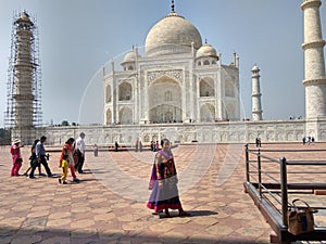 Indian Girl  standing in front of The Taaj Mahal which is located in Aagra