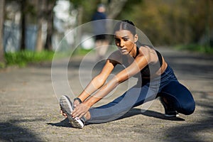 Indian girl, stretching and park to exercise, portrait and nature for fitness, relax and workout in city. Outdoor