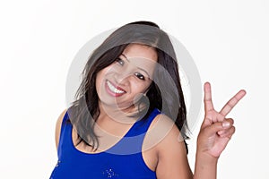 indian girl wearing a blue sleevless t shirt showing victory sign