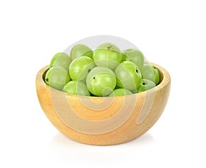 Indian gooseberry in wooden bowl isolated on white background