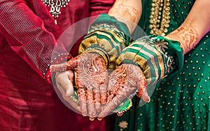 Indian groom and bride with henna paint