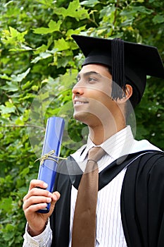 Indian guy in a graduation gown.