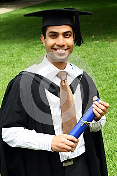 Indian guy in a graduation gown.