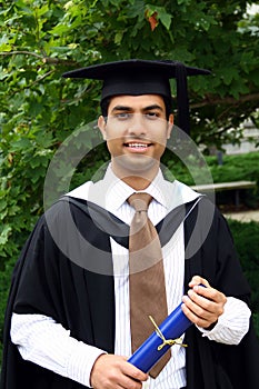 Indian guy in a graduation gown.