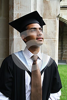 Indian guy in a graduation gown.