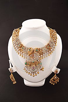 indian handcrafted antique gold plated bridal and festival temple jewellery necklace with matching earring.