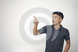 An indian handsome asian man wearing black shirt with white line and shocking expression on a white background