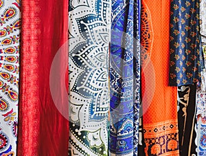 Indian hanging on the counter. Trade in fabrics from india. Fabric with patterns and patterns