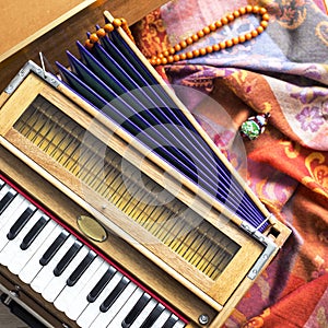 Indian harmonium, a traditional wooden keyboard instrument, close-up photo