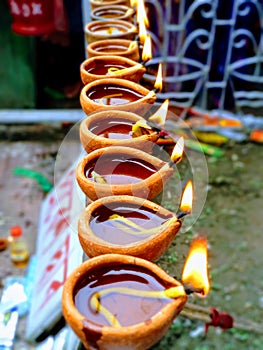 Indian hindhu tample . Prayer . Firing diya