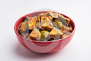 Indian Homemade Raw Mango Pickle or aam ka achar or Kairi Loncha in a bowl