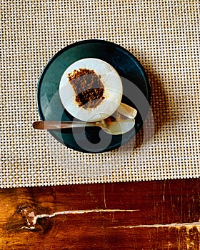 Indian hot coffee with spoon and pot on a table photo