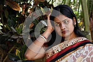 The Indian housewife in the casual clothing on a forest backgrou