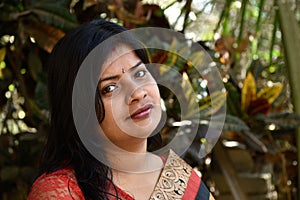 The Indian housewife in the casual clothing on a forest background