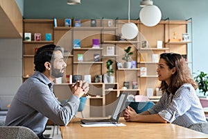 Indian hr employer listening latin candidate at job interview meeting.