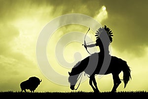 Indian hunting buffalo at sunset