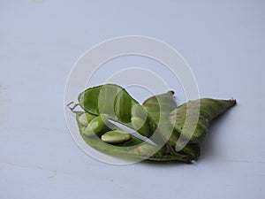 Indian Hyacinth Beans or Avarekai with and without peeled seeds  on white background