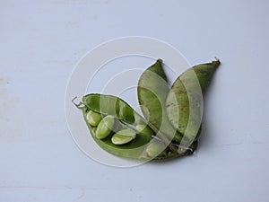 Indian Hyacinth Beans or Avarekai with and without peeled seeds  on white background