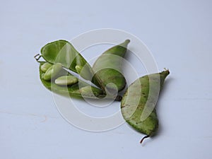 Indian Hyacinth Beans or Avarekai with and without peeled seeds  on white background