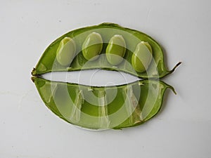 Indian Hyacinth Beans or Avarekai with and without peeled seeds  on white background