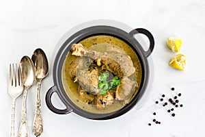 Indian Kali Mirch Chicken Curry in a Kadhai with Cilantro and Lemon