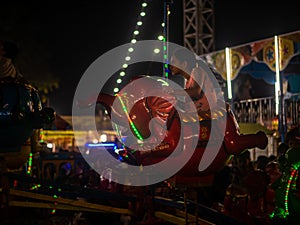 Indian kids enjoying carousel ride in elephant at amusement park