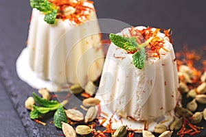 Indian kulfi dessert, ice cream with safron, mint, nuts photo